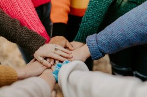 an image of many hands linked together in support.